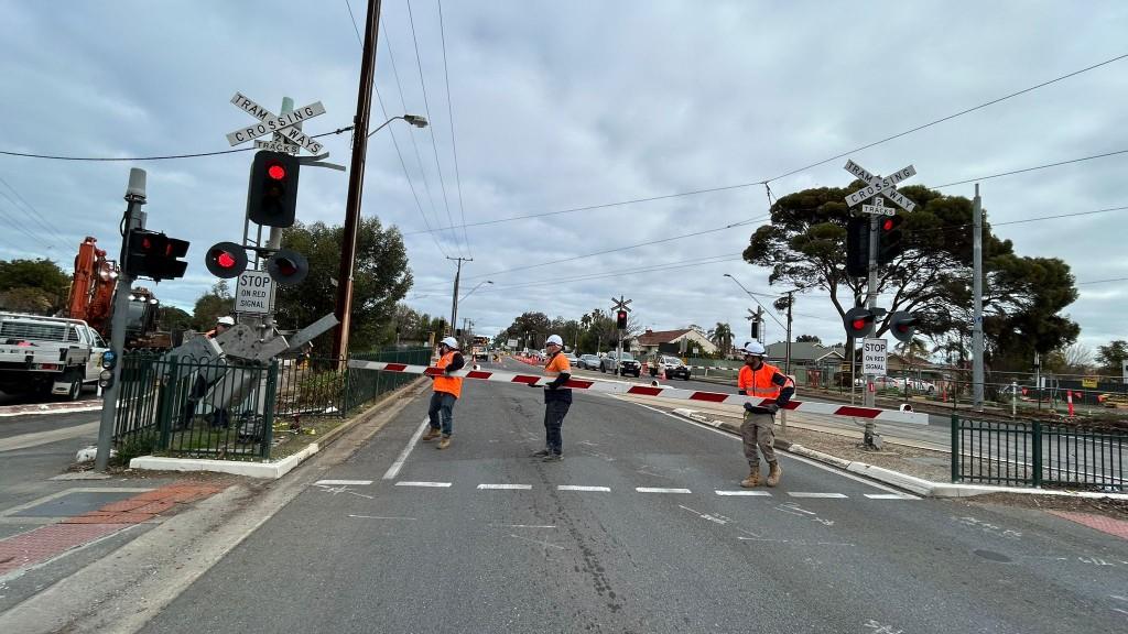 Tram crossing boom gates during TGSP works